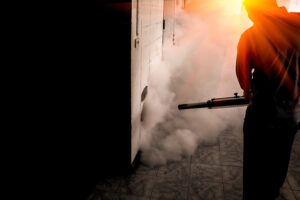 A man use fumigation mosquitoes machine for kill mosquito carrier of Zika virus and dengue fever prevention outbreak in school at the rainy season.Soft and blur focus.